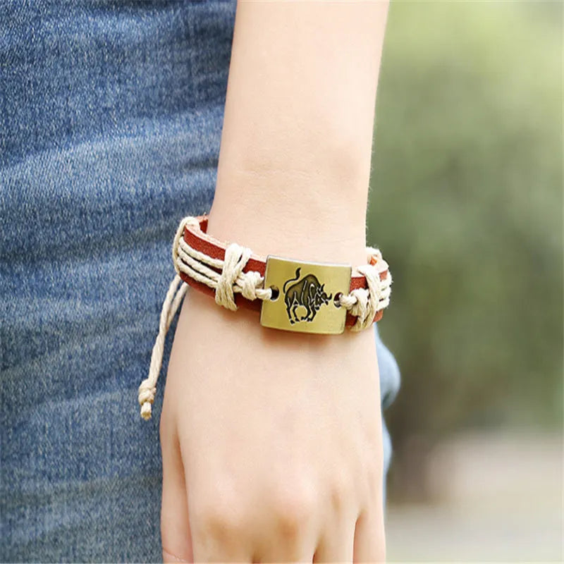 12 constellation alloy bracelet set with copper leather and braided hemp rope on a neutral background