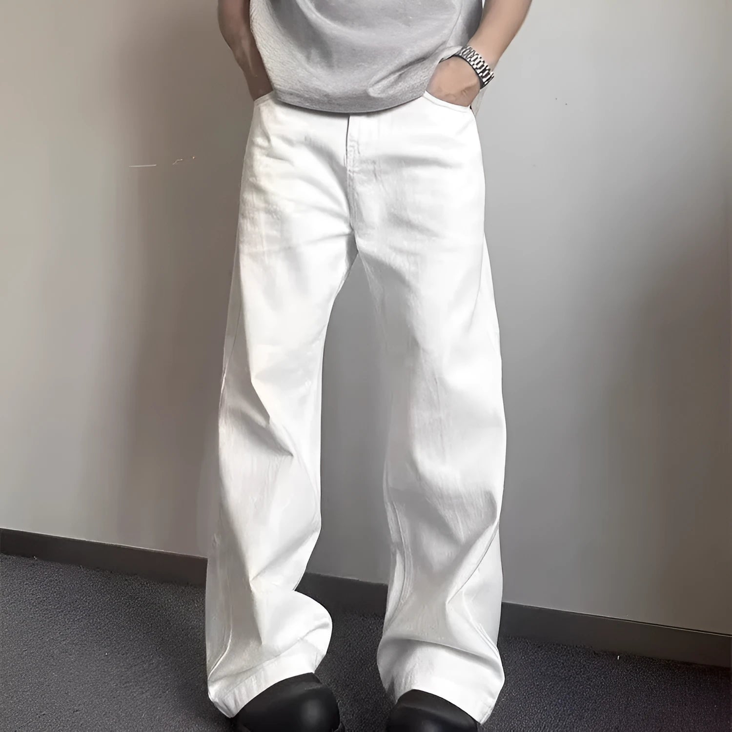 Men's white loose straight-leg wide-leg denim jeans on a mid-waist with a zipper fly.