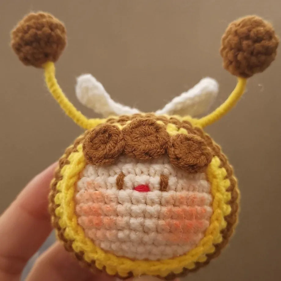Handmade crocheted bee colony wool doll with bee pendant accessory in plush soft toy construction
