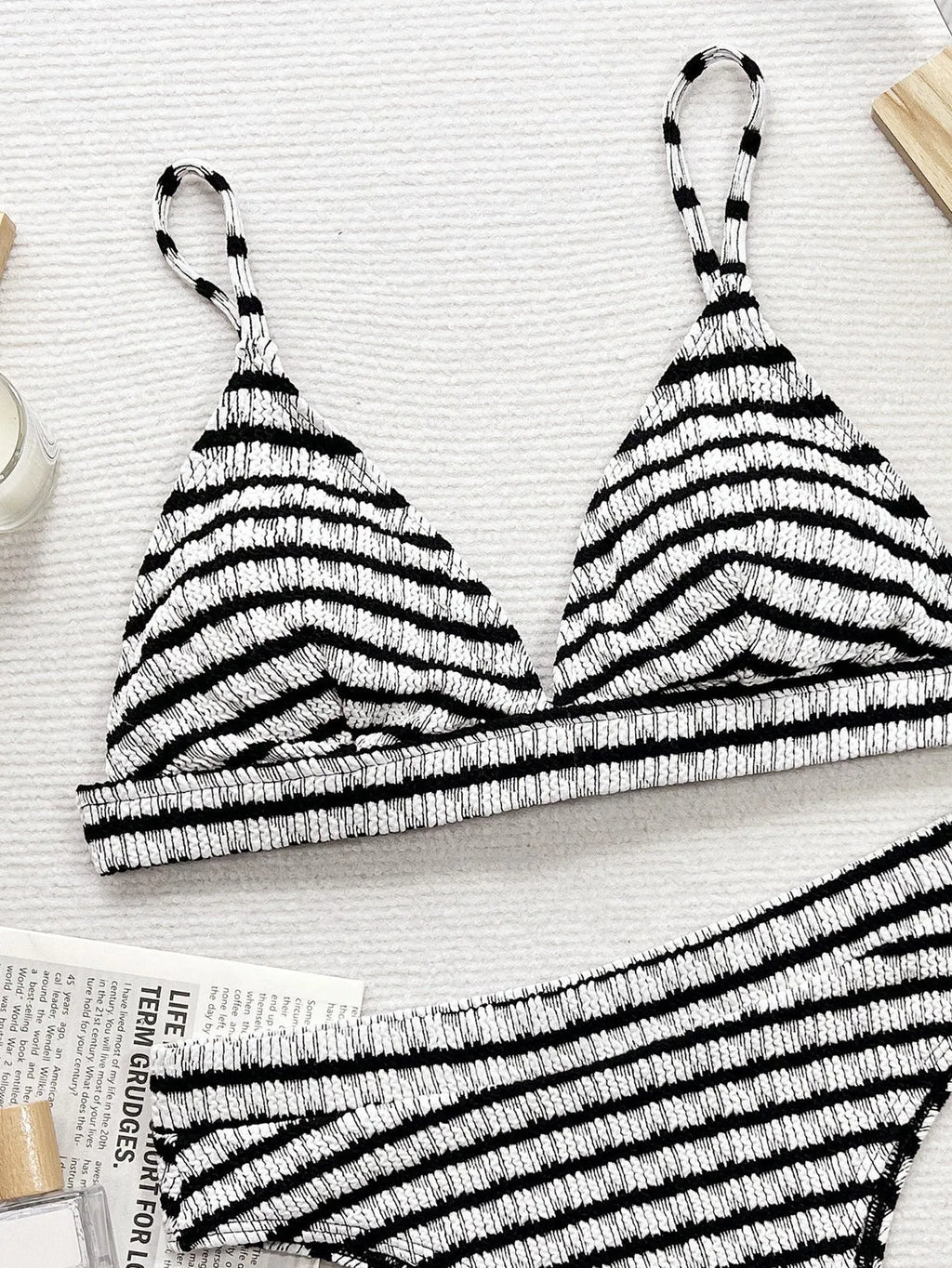 Women's black and white contrast separated bikini set on model, briefs style bottom, solid colour design