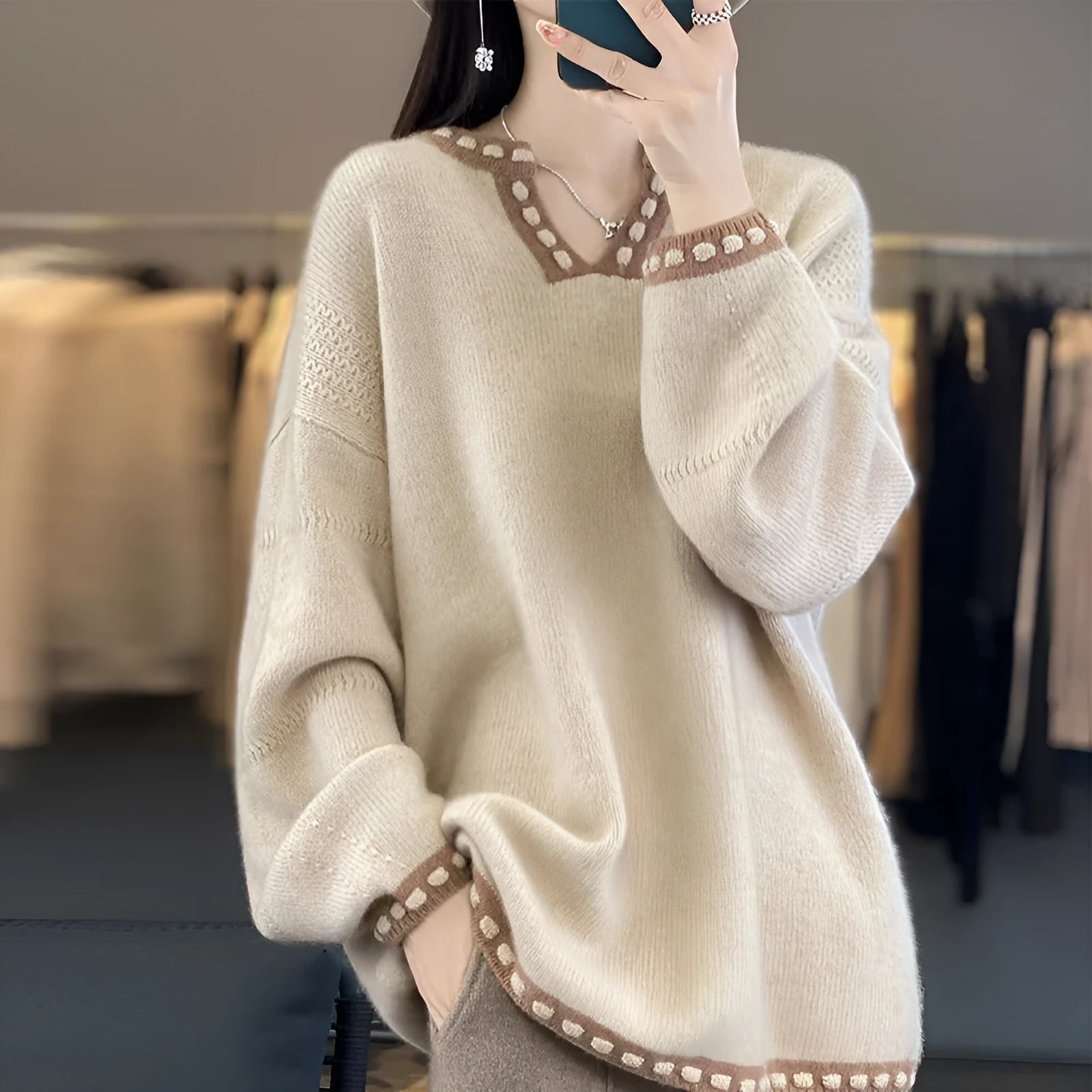 Women's camel V-neck viscose pullover sweater with long sleeves laid flat.