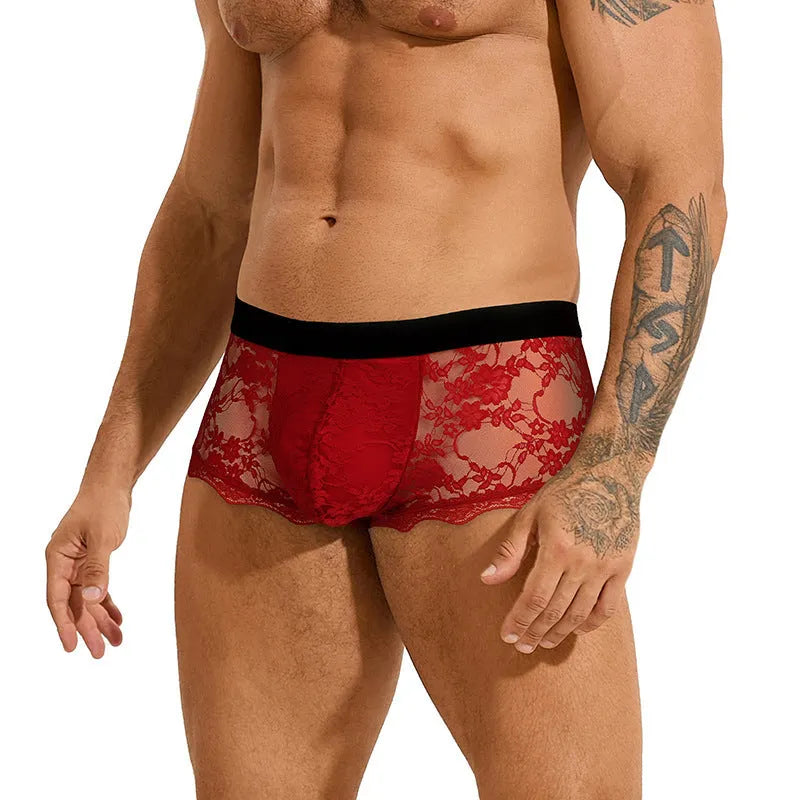 Men's black lace briefs with a hollow-out, see-through design on a neutral background.