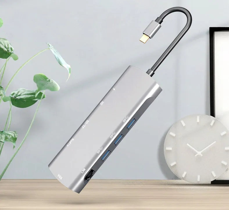 Grey aluminium USB-C docking station with 4K HDMI, VGA, and USB ports, showing 140mm attached cable.