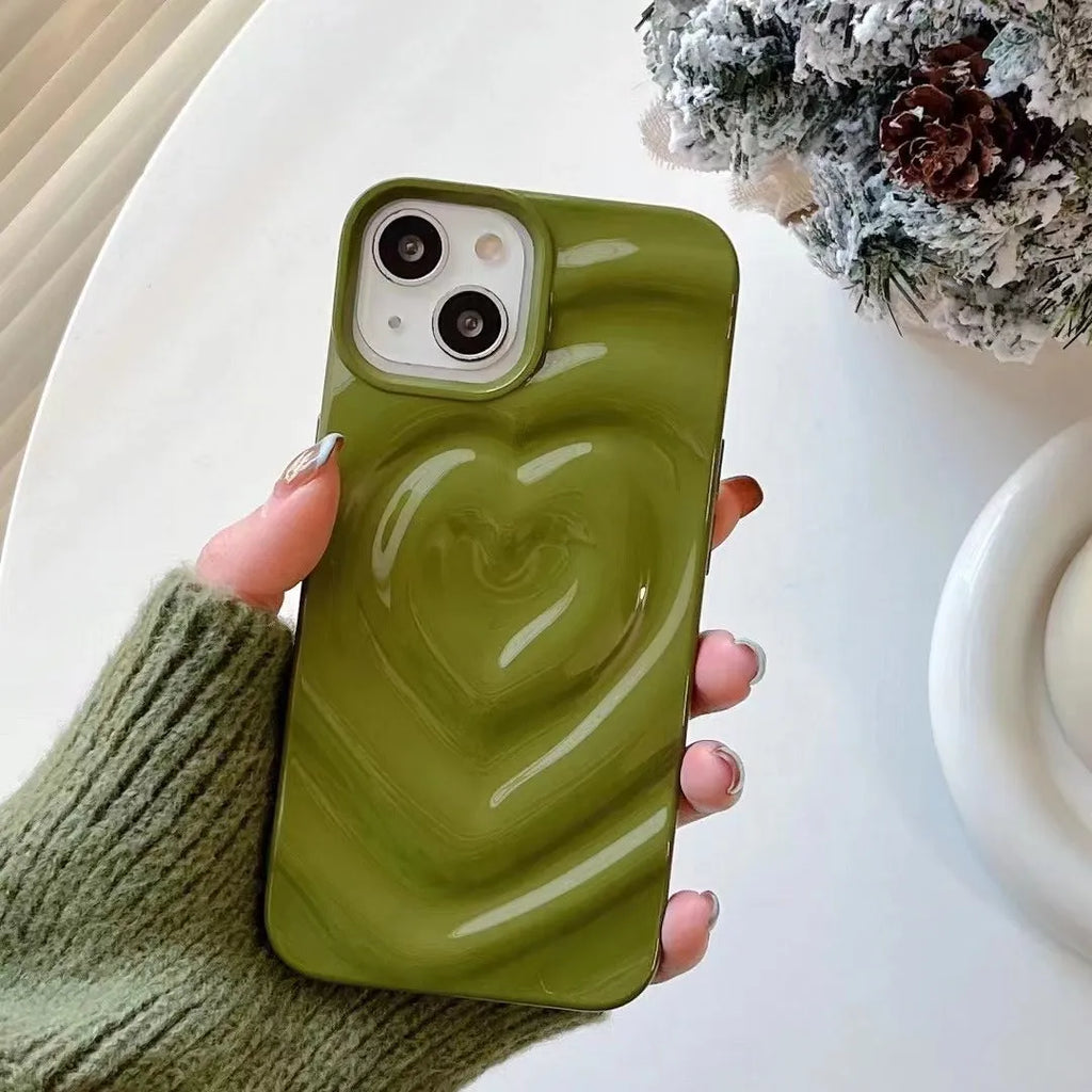 Solid colour iPhone case with a raised 3D love heart design, shown in bright purple.