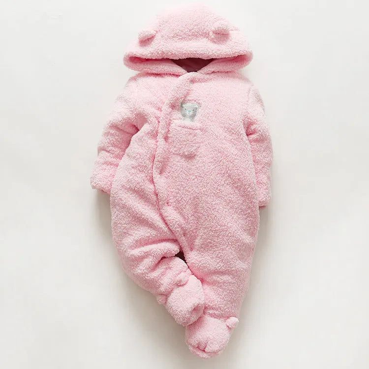 Baby wearing a cotton padded winter jumpsuit with long sleeves, available in marrón, pink, or white colours.