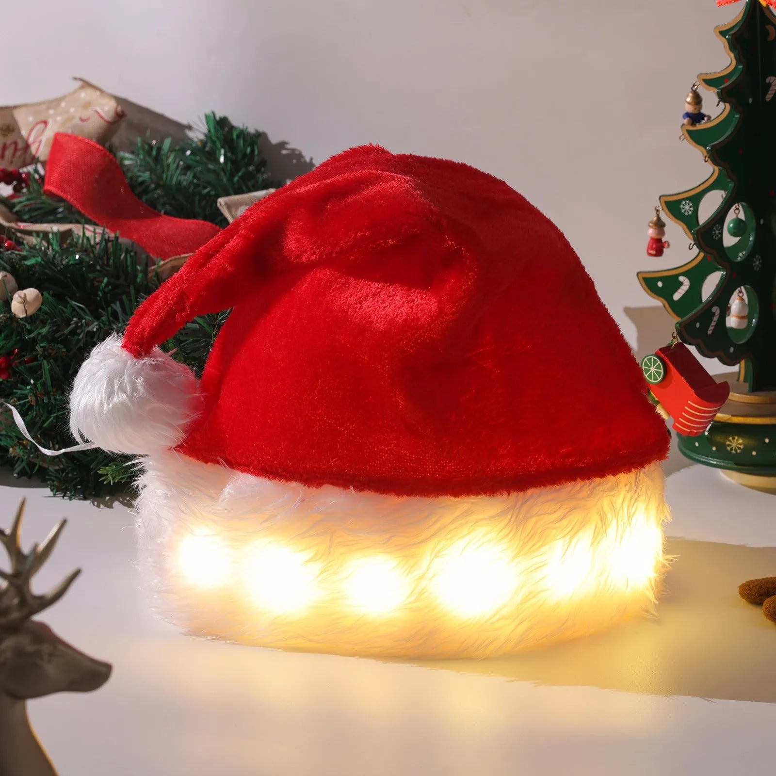 Red and white plush Santa hat with LED twinkling lights around brim and pom-pom
