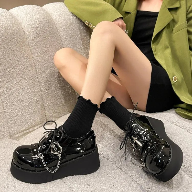 Solid black punk platform shoes with leather upper, rubber sole, and visible stitching detail