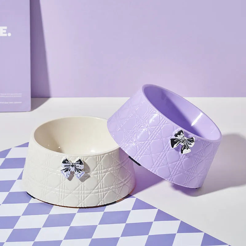 Pet food bowl with diamond pattern and bowknot decoration in black, purple or white with pink or silver bow
