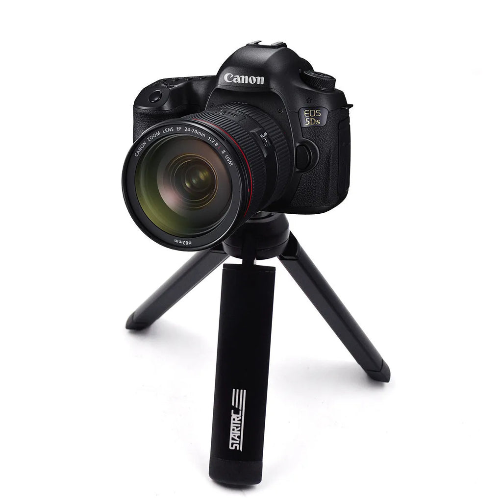 Silver aluminium alloy phone bracket for iPhone shown in clip and tripod style next to a mobile phone.