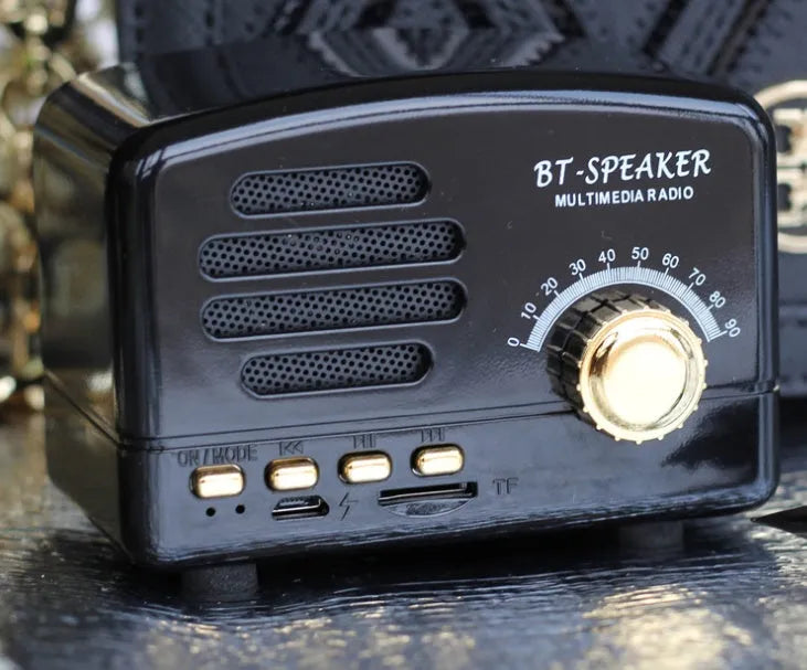 Vintage wood grain finish Bluetooth speaker with compact design on a wooden table.