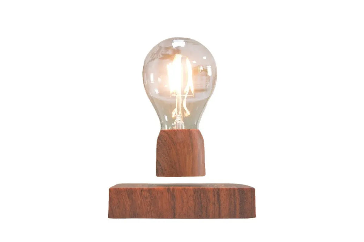 Magnetic levitation desk lamp with a floating glass bulb above an imitation wood base.