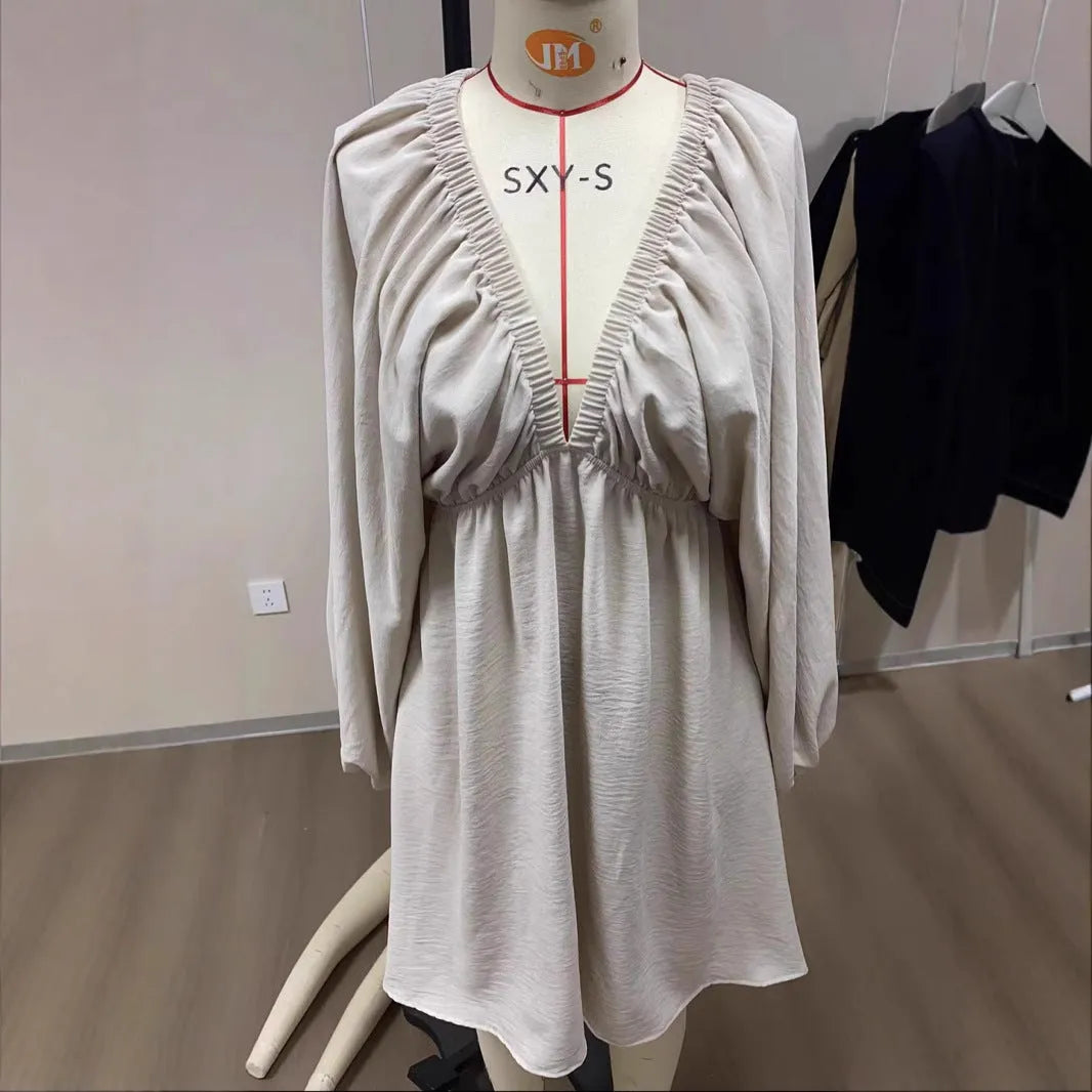 Women's apricot V-neck dress with long puff sleeves and a swing flounced skirt.