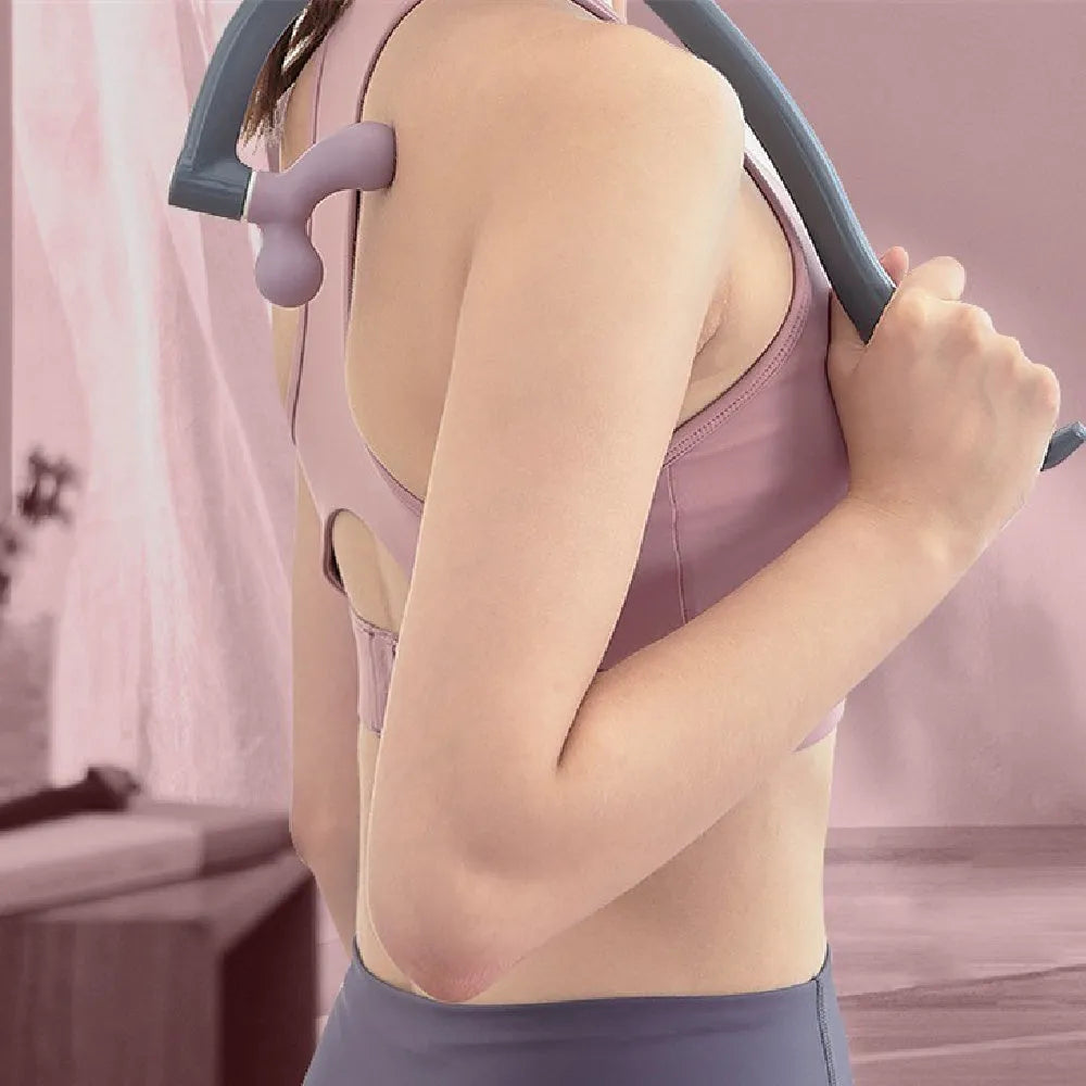 Light purple plastic scapula seam massager hook on a neutral surface