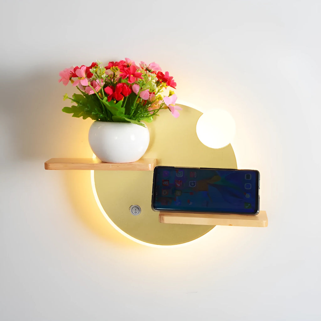 Black round bedside lamp with USB charging port on a wooden nightstand.