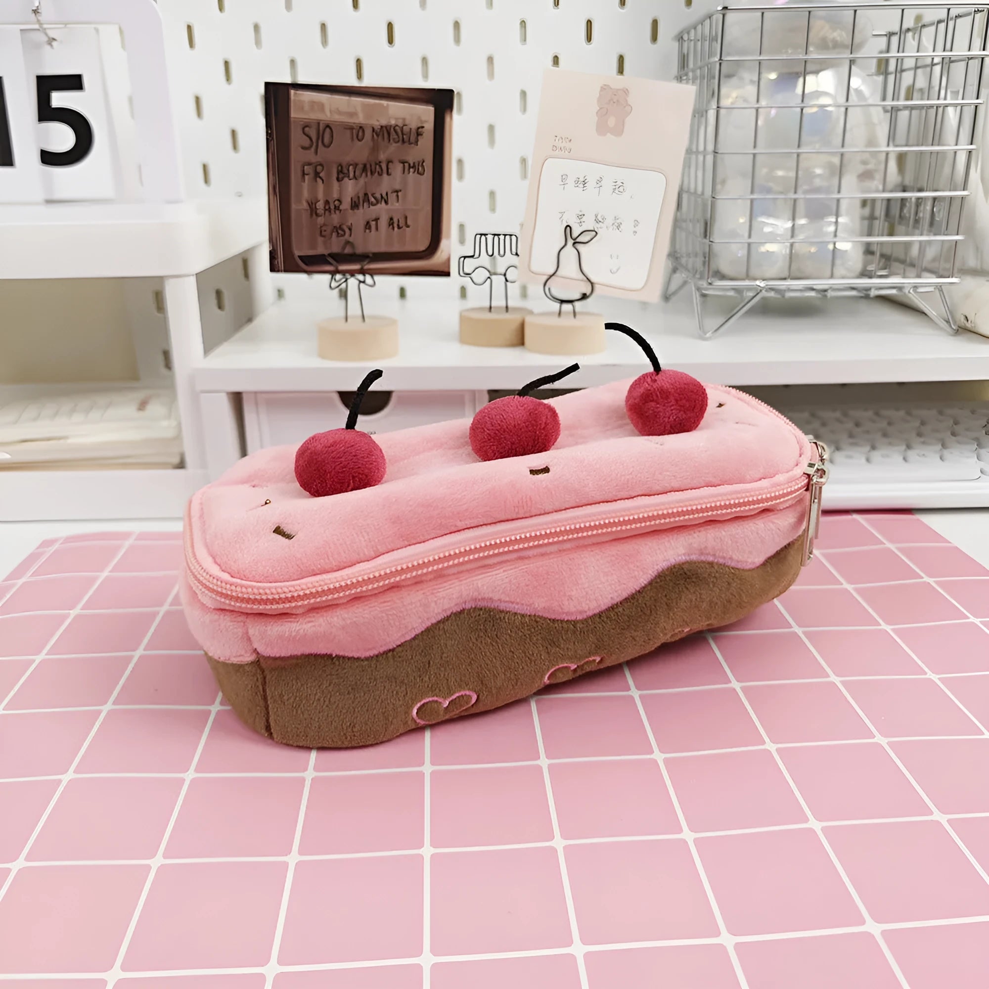 Soft red velvet pencil bag with a cherry cake print and a white zip.