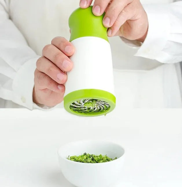 White plastic herb grinder mill with stainless steel blades and ergonomic handle for chopping fresh herbs