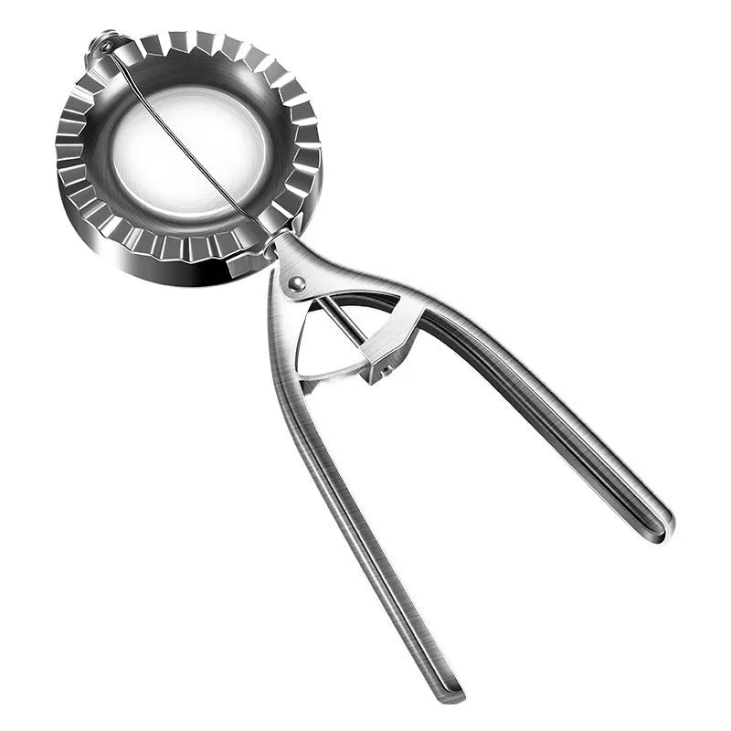 Silver stainless steel manual dumpling press tool on kitchen work surface