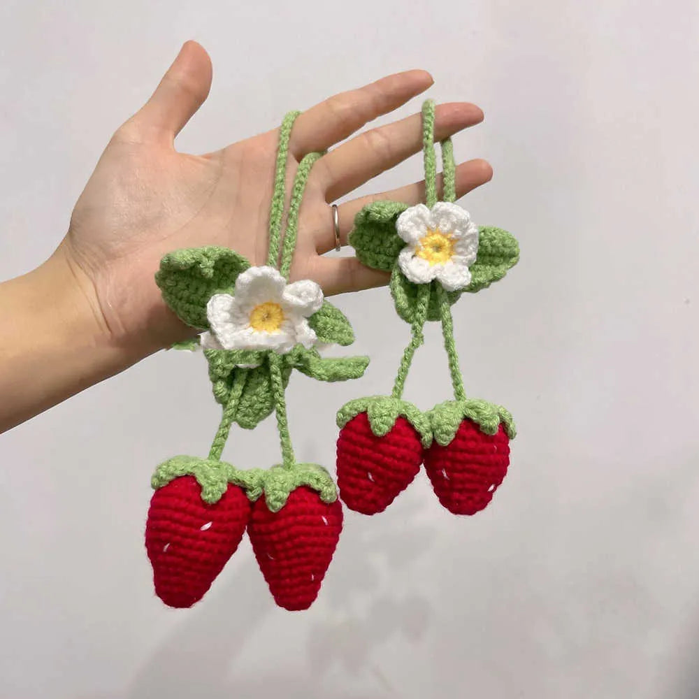 Handwoven strawberry-shaped car pendant made from cotton and hemp fibres.