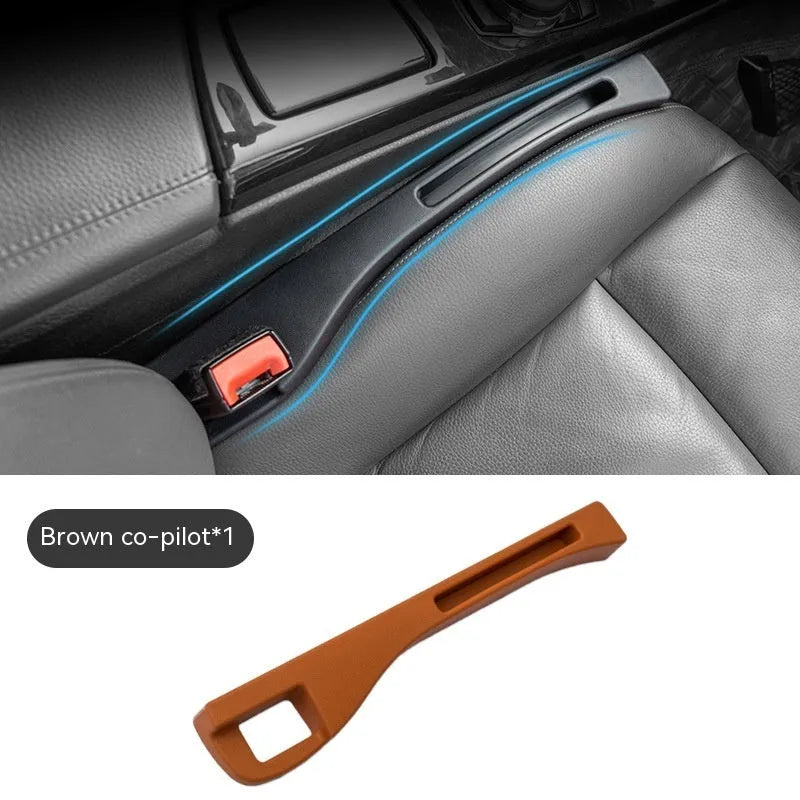 Black plastic car seat gap storage organiser box with handle inserted between vehicle seats