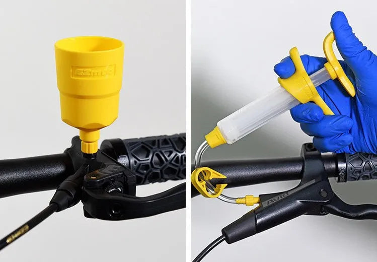 EZmtb bicycle hydraulic disc brake bleed kit with syringes, bottles, adapters, and tools laid out.