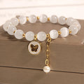 White geometric Cat's Eye crystal bracelet on a wrist, showing its handcrafted Korean-style design.