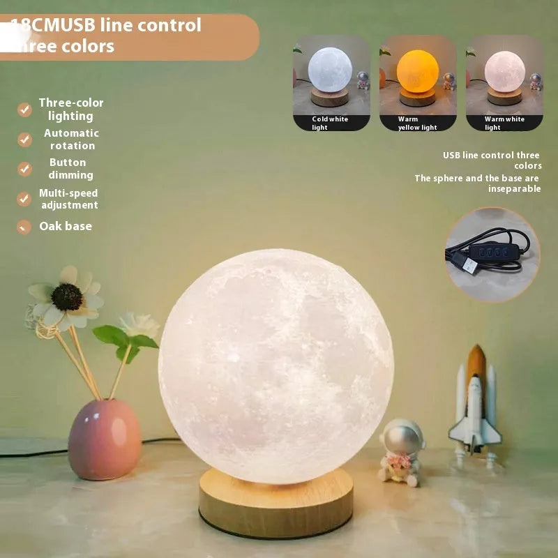 Rotating moon night light on wooden base showing three colour options and size scale