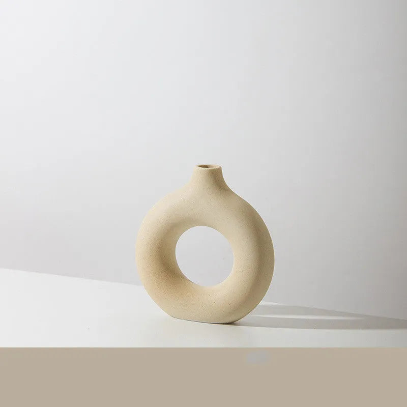 A simple modern frosted porcelain biscuit vase in a neutral colour, for flower arranging.