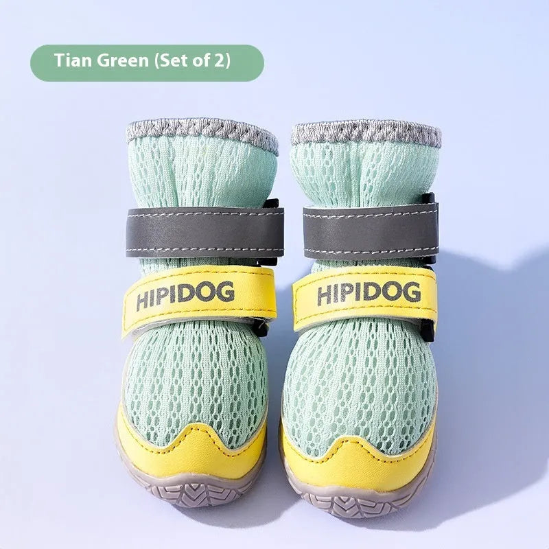 Pair of light blue breathable dog shoes with mesh upper and PU sole on a wooden surface.