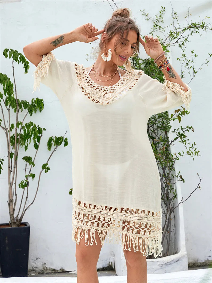 Apricot hand-crocheted women's beach dress on a hanger.
