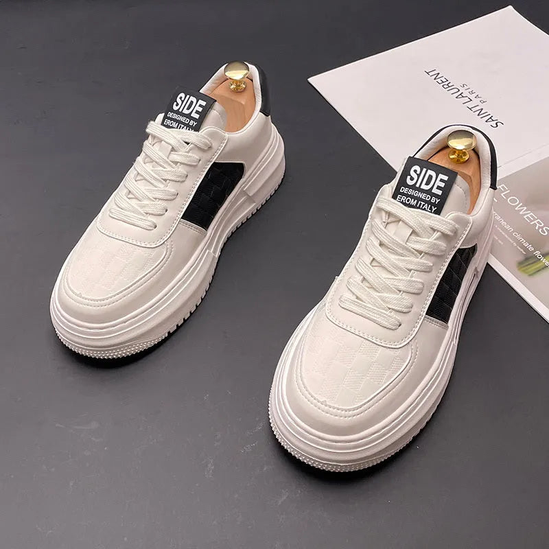 A pair of white, black, and green casual sports shoes with cloth uppers and rubber foam soles.