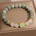 Close-up of a women's oil green emerald crystal bracelet featuring a five-piece sutra design.