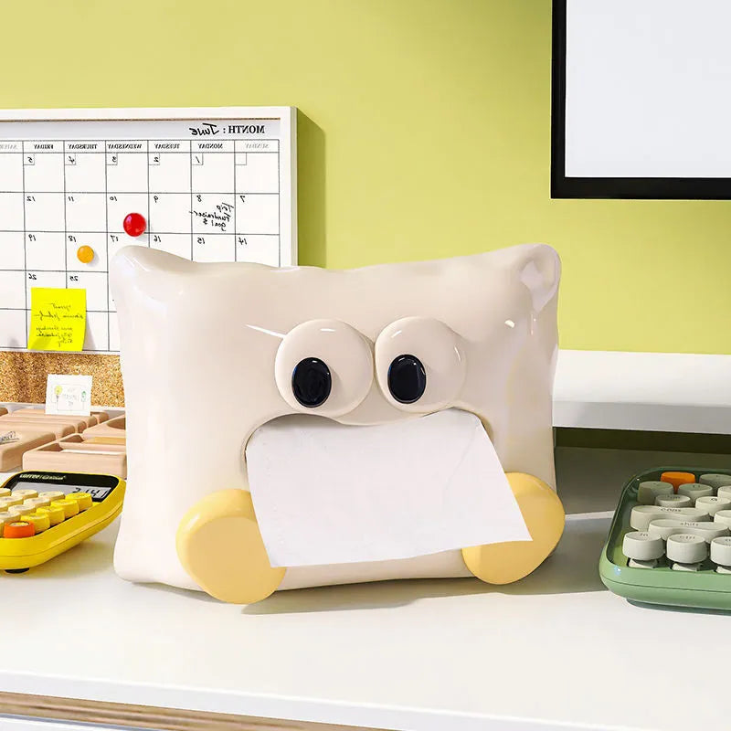White ceramic tissue box with a smooth, glazed finish on a wooden coffee table.