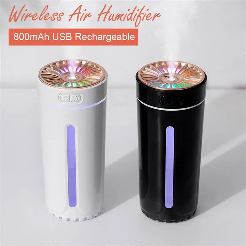 Black wireless USB car humidifier with colourful LED lights on a desktop next to a cup holder.