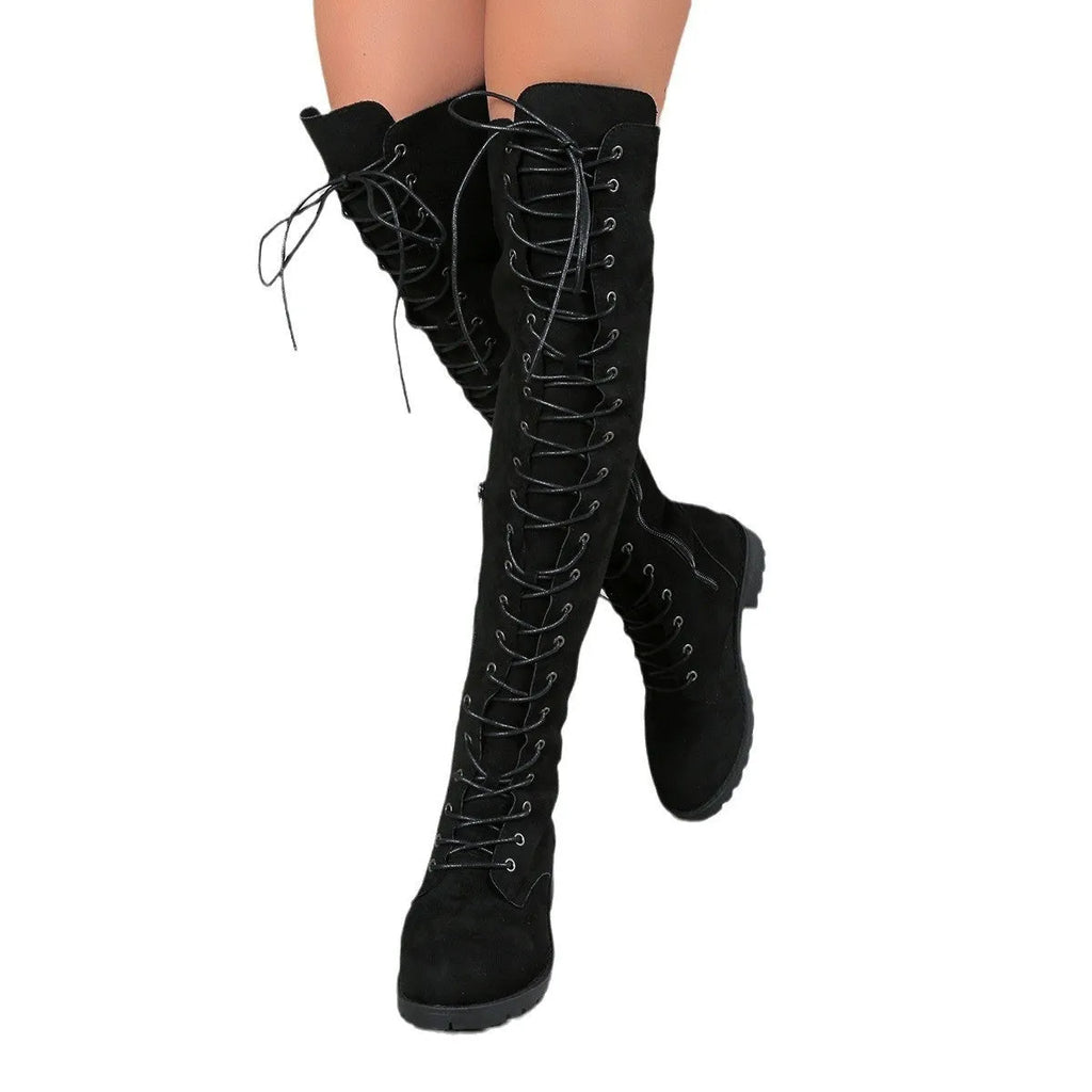 Black lace-up over-the-knee boots with a round toe and flat rubber sole on a neutral background.