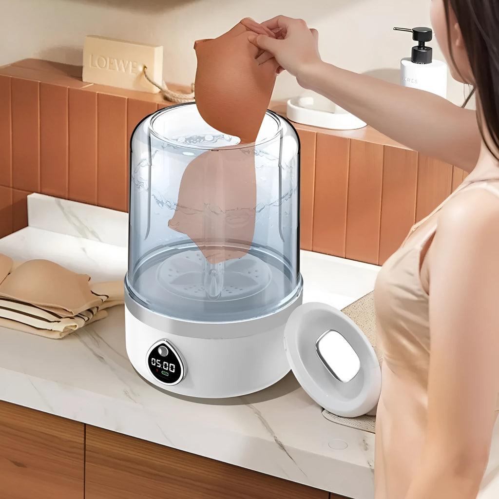 Portable white mini washing machine with USB cable on a countertop.