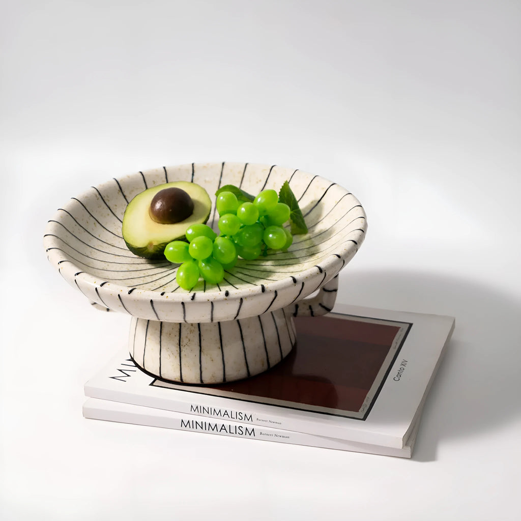 Black and white striped synthetic resin fruit plate on a table