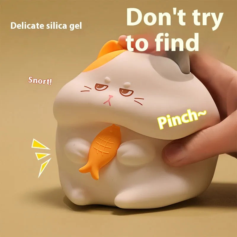 Yellow Greedy Cat cartoon desktop night light with USB cable on a wooden desk.