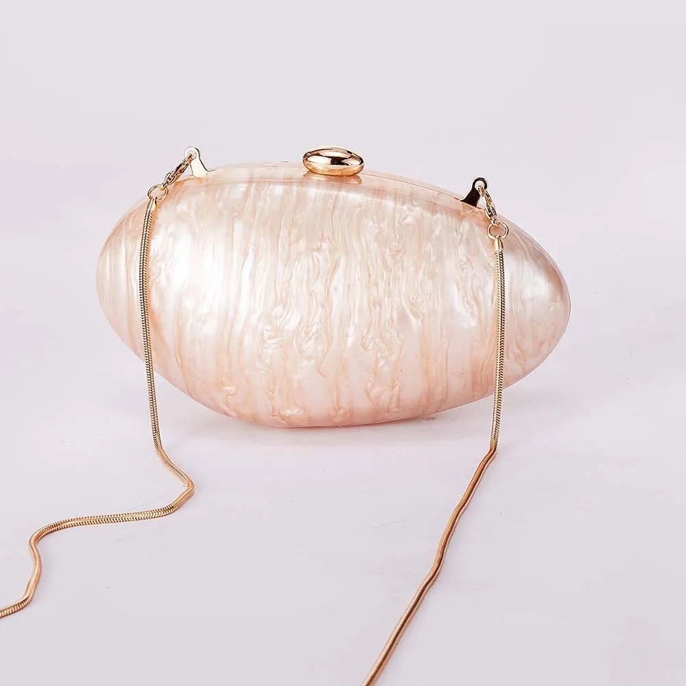 Acrylic oval crossbody bag shown in black with chain strap and hard shell