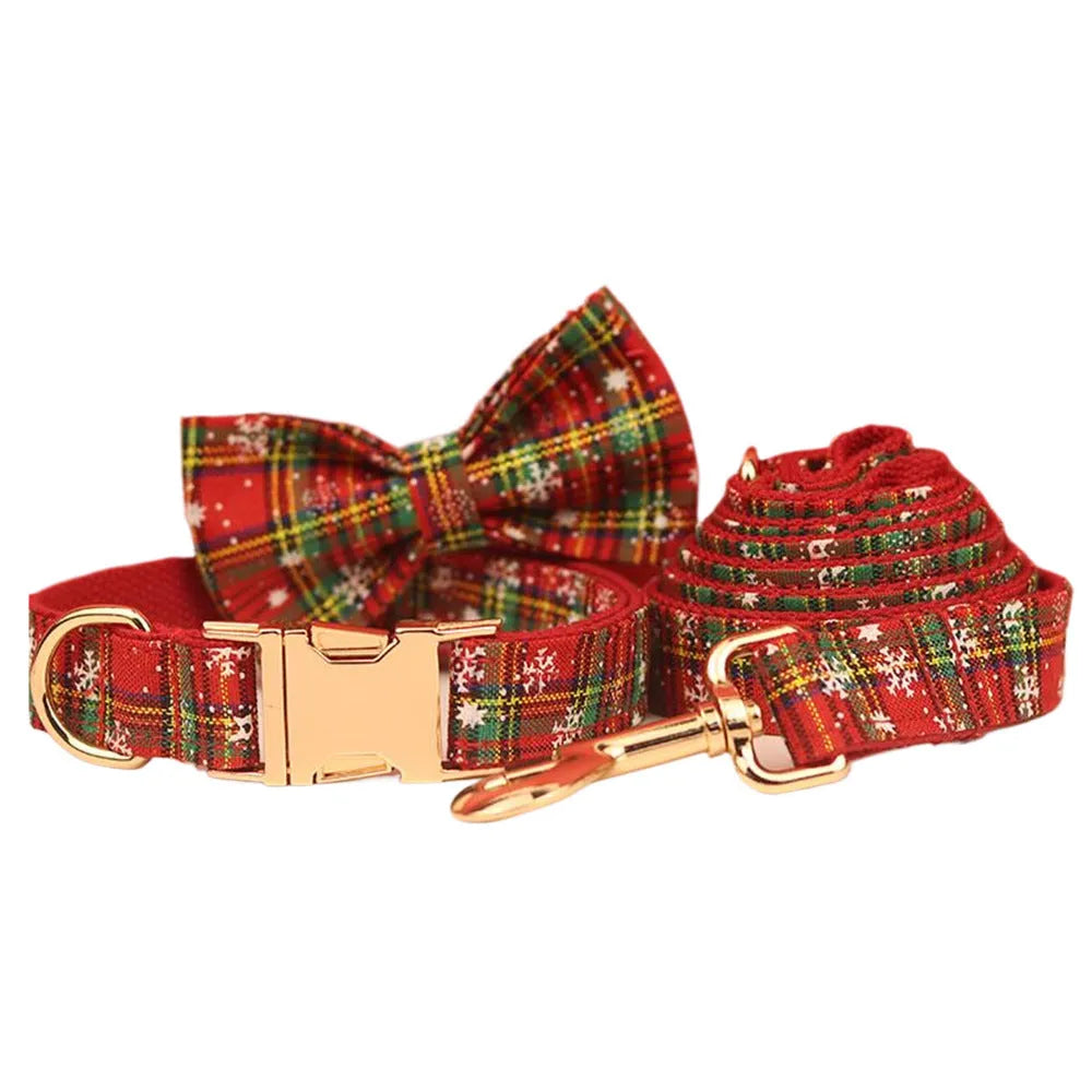 Red snowflake Christmas dog collar and leash set with plaid design and decorative bow on dog vest