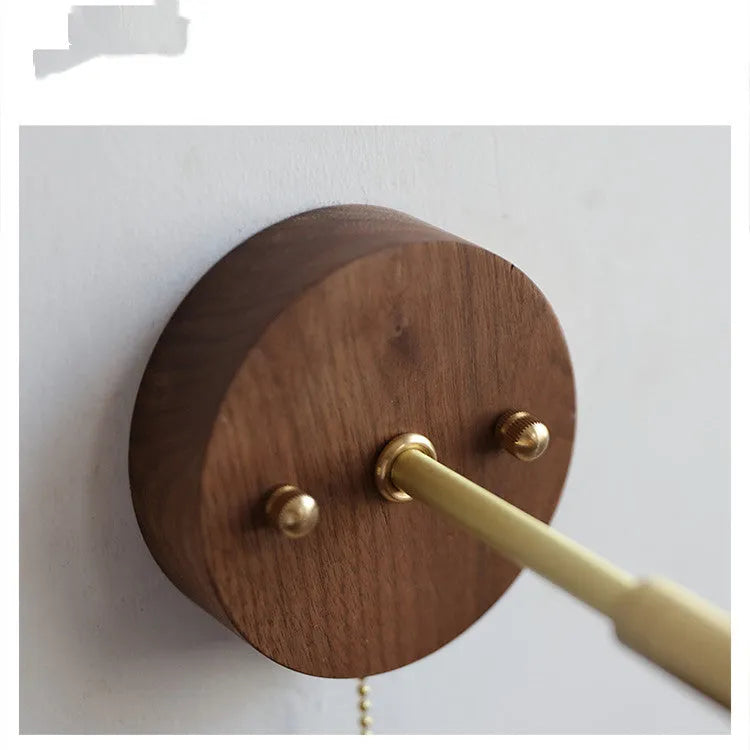 Nordic bedside wall lamp in walnut wood colour on a bedroom wall.