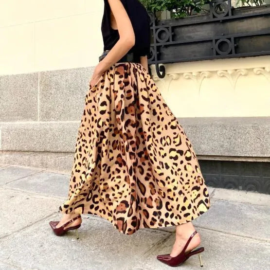 Brown leopard print women's long A-line skirt with a deep hem, shown on a hanger.