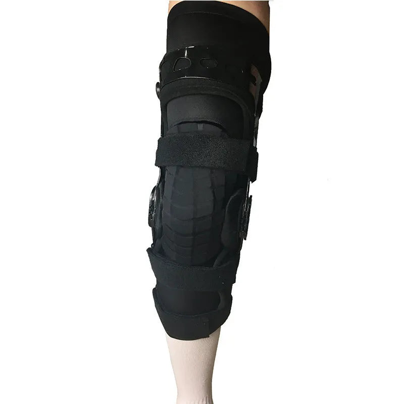 Black anterior ligament knee pad with metal stabiliser showing sandwich construction and sizing options