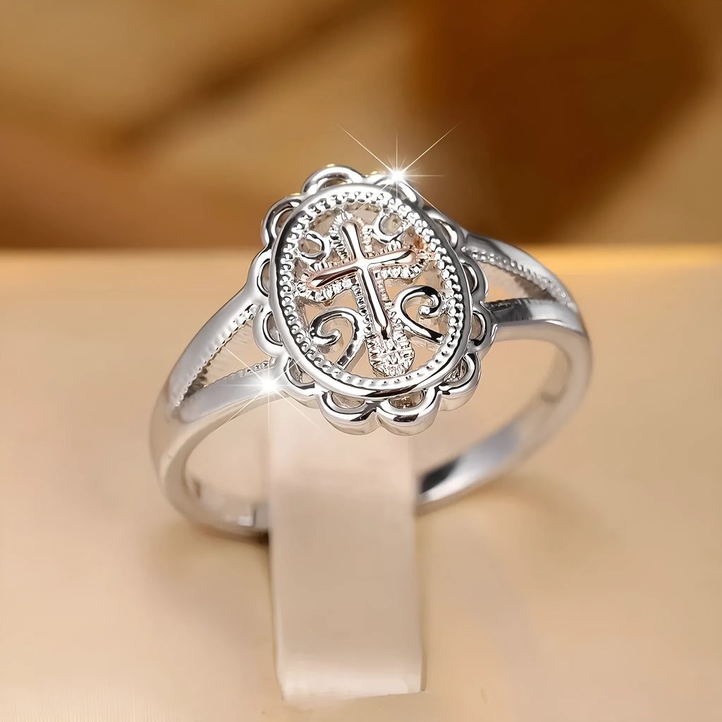 Silver-coloured personalised cross lace ring showing intricate patterning and cross design on alloy band