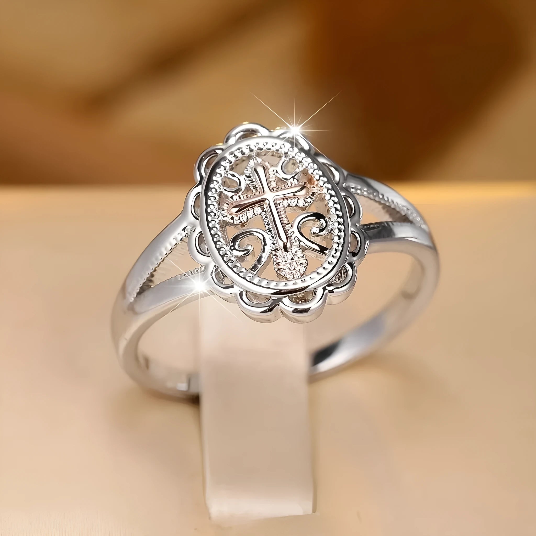 Silver-coloured personalised cross lace ring showing intricate patterning and cross design on alloy band