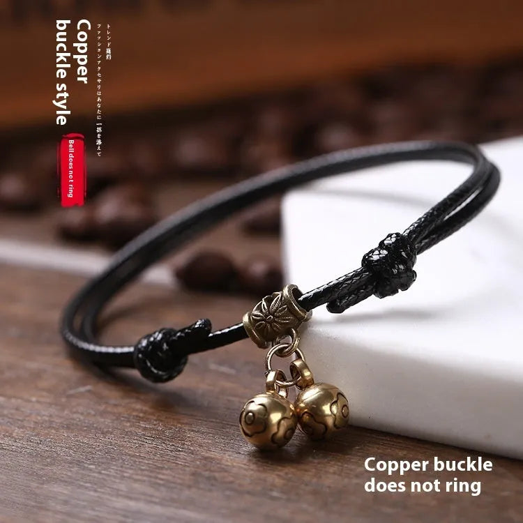 Adjustable nylon rope dog collar with brass bell, shown in black colour on a size guide