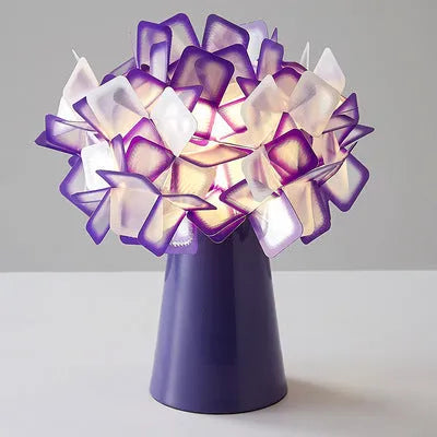 Nordic-style decorative table lamp with metal holder in black, showing warm, white, and neutral light settings.