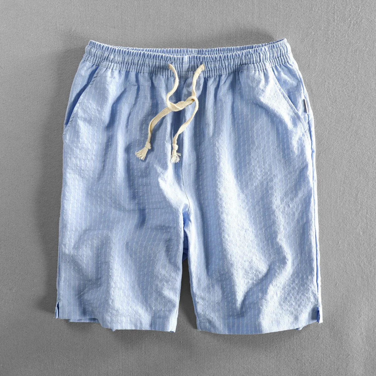 Men's striped casual shorts in a loose straight-leg style on a plain background.