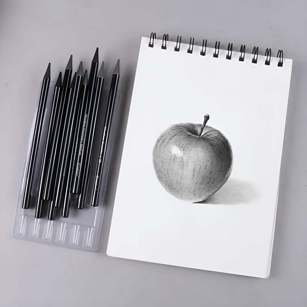 Set of nine drawing pencils with wooden shells, comprising six graphite and three carbonised pencils, on a suction card.