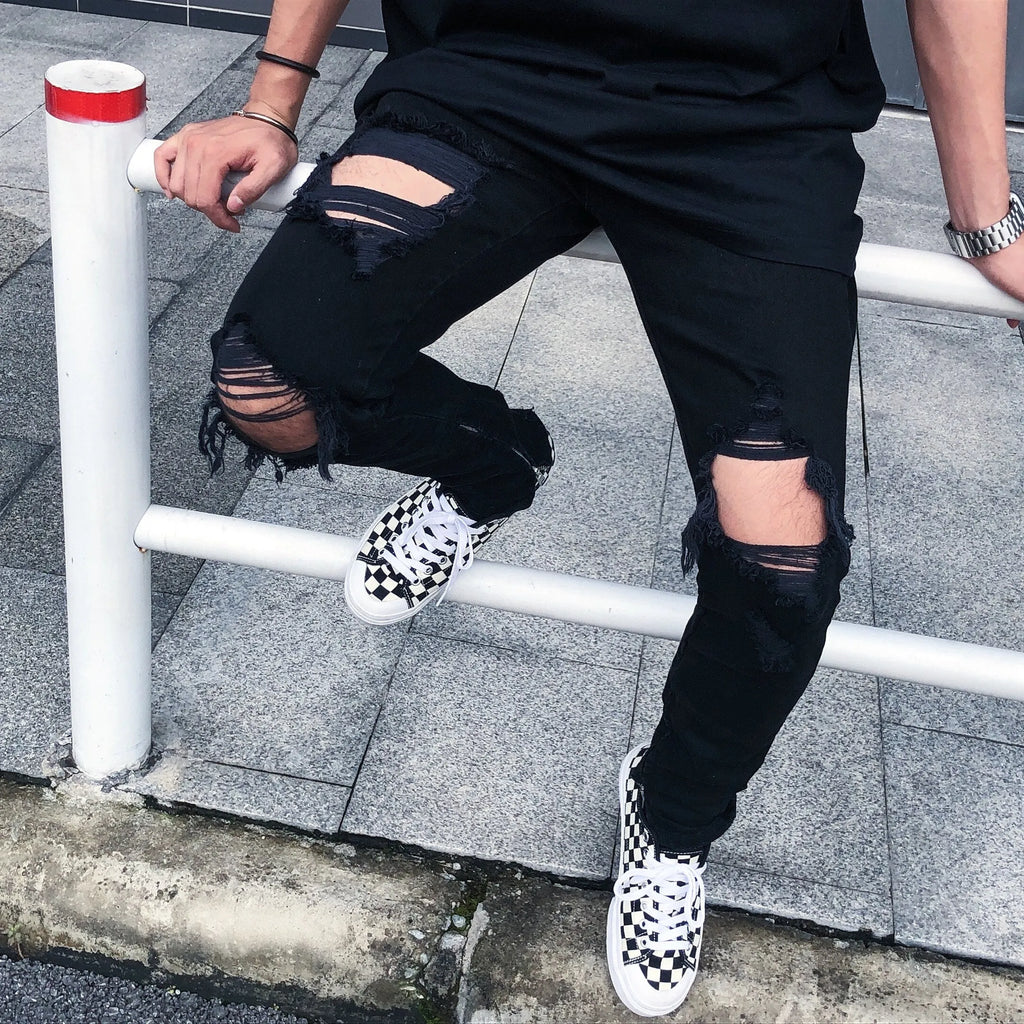 Men's black torn jeans in cotton elastic denim with raw edges, medium to low waist and zipper placket, sizes M to 2XL.