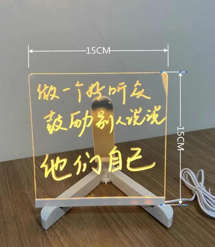 DIY acrylic LED message board on a desk with handwritten notes, glowing softly, next to colourful pens.